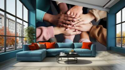 a diverse team stacking their hands in a circle Wall mural