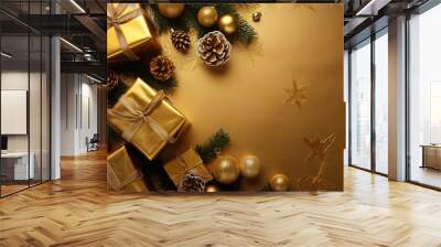 A festive display featuring golden presents, ornaments, and pinecones, arranged with greenery on a glittering gold surface. Wall mural