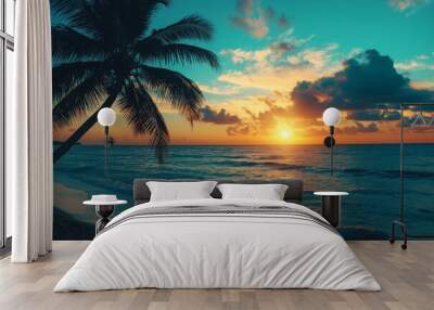 A picturesque tropical beach scene with a silhouetted palm tree, waves, and a stunning sunset over the ocean horizon. Wall mural