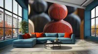 A red wooden figure stands prominently among others, highlighting individuality and standing out. Wall mural