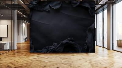 An abstract black background showing crumpled dark fabrics, providing a textured and moody aesthetic. Wall mural