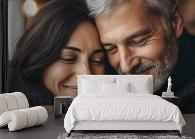 Close-up of a smiling couple in warm embrace, showcasing love and companionship in a cozy modern setting. Wall mural