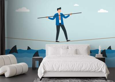 Businessman walking a tightrope with balancer stick over shark in water. Obstacle on road, financial crisis. Risk management challenge. Wall mural