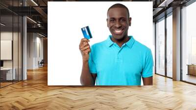 Smiling guy holding credit card Wall mural