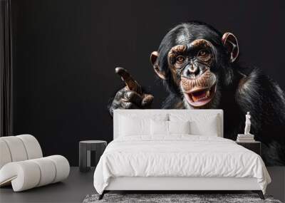 A photo of a smiling chimpanzee pointing with his finger on a black background. The monkey points his finger at the free space. Wall mural