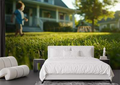 Close-up of the grass in the yard in front of the house. A child running across the lawn in the background of a house. Wall mural