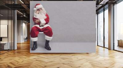 Bored Santa Claus sitting and waiting Wall mural