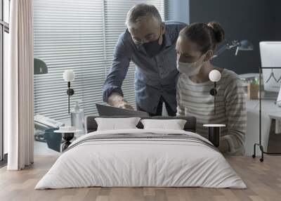 Business people working together in the office and wearing face masks Wall mural