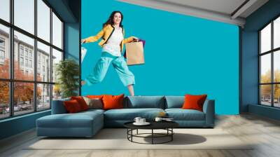 Cheerful happy woman enjoying shopping Wall mural