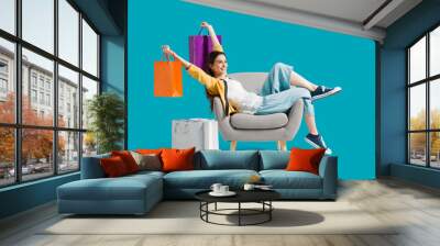 Cheerful shopaholic woman with shopping bags Wall mural