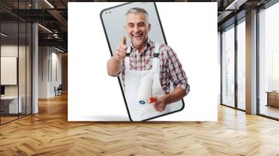 Confident painter and decorator  in a smartphone videocall and smiling, online  service concept Wall mural