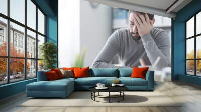 exhausted man with headache Wall mural