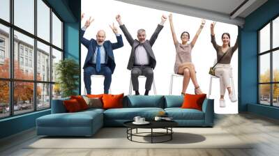 Happy successful people celebrating with raised arms Wall mural