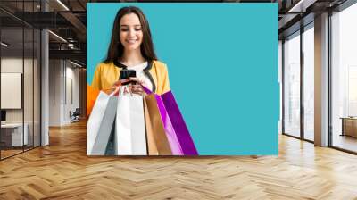 Happy woman using shopping apps Wall mural