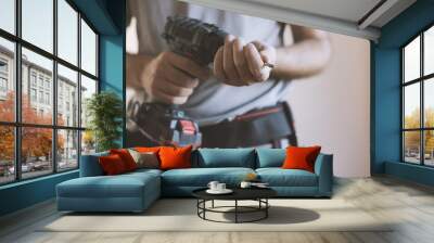 Professional handyman changing a drill bit Wall mural