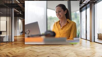 Smiling woman working from home Wall mural