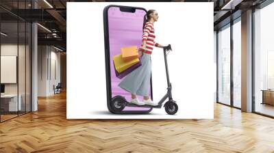 Woman doing online shopping and riding a scooter Wall mural