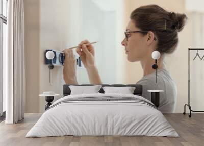 Woman working with a spirit level Wall mural