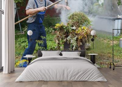 man firing grass in the garden Wall mural