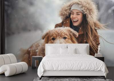 Young happy smiling couple having fun in winter park with their dog outdoors. Wall mural