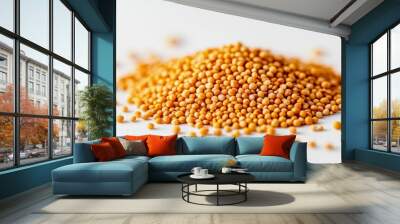 A small pile of whole mustard seeds with their tiny, round shape and yellowish color, scattered on a white background Wall mural