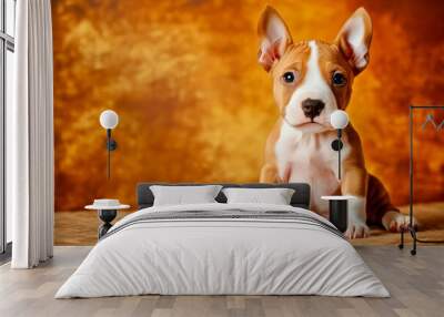 Bull Terrier puppy, small with egg-shaped head, sitting with a curious look, playful and adorable Wall mural