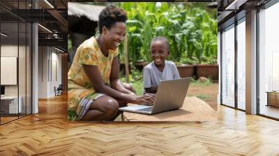 African girl using laptop in local village in Africa Wall mural