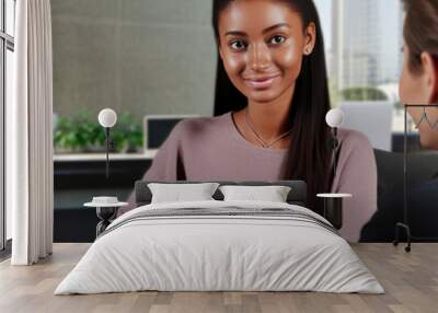 female african business woman smiling and working with client. Business meeting concept Wall mural