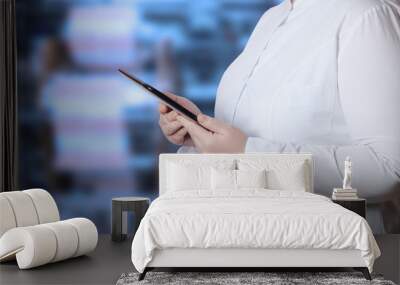 a woman in a white uniform robe with electronic device in her ha Wall mural