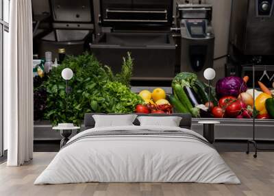 Fresh greens in metal bowl on professional kitchen. Selective fo Wall mural