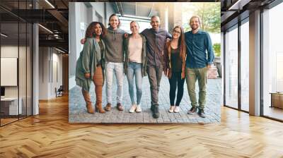 Future, here we come. Portrait of a group of happy young students standing together outdoors on campus. Wall mural