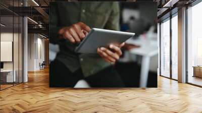 Close-up of businessman's finger touching screen of a digital tablet at the office Wall mural