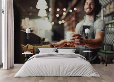 Closeup of waiter hand serving a cup of cold coffee to customer at counter in cafe Wall mural