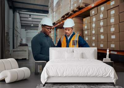 Male warehouse workers discussing about stock while using digital tablet Wall mural