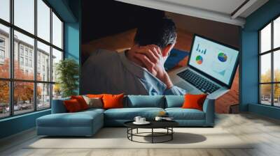 Man working on business project using laptop suffering from neck pain Wall mural