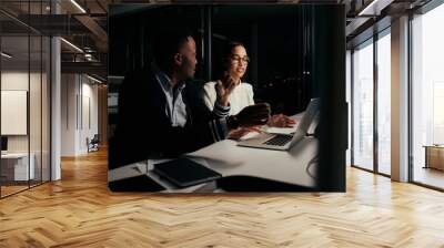 Multiethnic business people discussing the project on laptop at late night in new modern office Wall mural