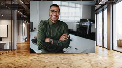 Portrait of a happy confident young african american businessman standing with his arms crossed looking at camera Wall mural