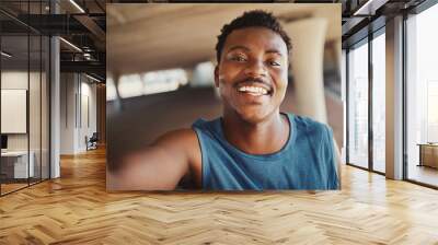 Portrait of a smiling young african american man taking selfie after jogging at outdoors Wall mural