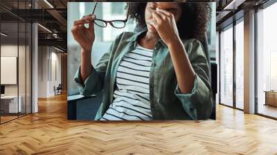 Stressed young businesswoman in the office Wall mural