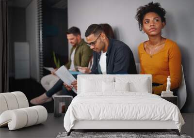 Unemployed young african american woman feeling stressed about tedious waiting sitting in queue with other candidates for job interview Wall mural