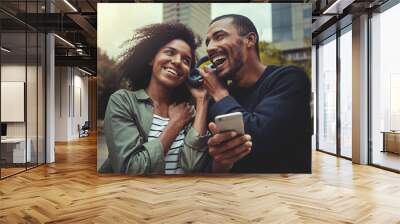 Young couple listening music on one headphone Wall mural