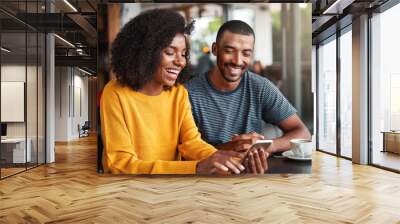 Young couple watching video on mobile phone Wall mural