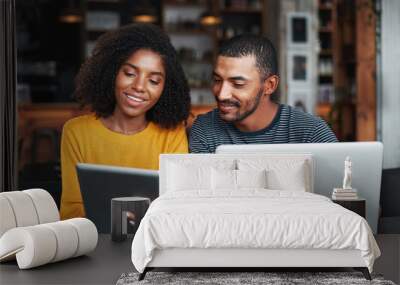 Young couple with laptop and digital tablet in café Wall mural