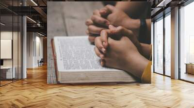 Close-up two christian read bible. Hands folded in prayer on a Holy Bible on wooden table. online group worship, World Day of Prayer, international day of prayer, hope, gratitude, thankful, trust Wall mural