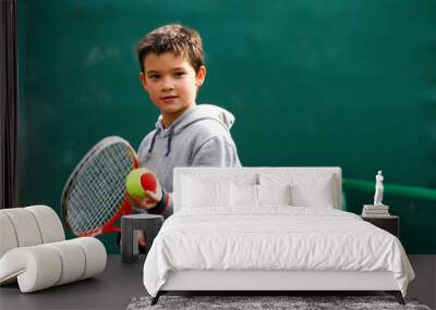 Little tennis player on a blurred green background Wall mural