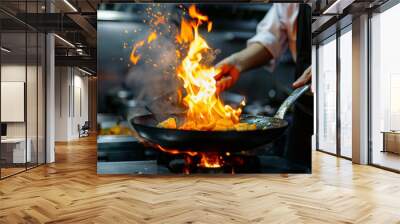 Close-up Professional chef hands cook food with fire in kitchen at restaurant. Wall mural