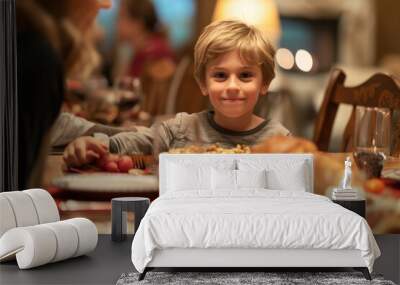 Medium shot of young boy at dining room table during multigenerational family celebration dinner  Wall mural