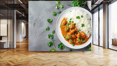 Traditional Indian dish chicken curry with basmati rice and fresh cilantro on rustic white plate on gray concrete table background from above. Indian dinner meal  Wall mural