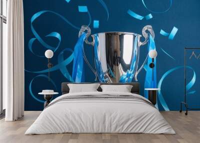 A photo of a gleaming trophy set against a dark blue background.  Wall mural