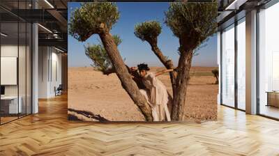 Fashion shooting in the desert, professional model and stylish Muslim clothing. Wall mural